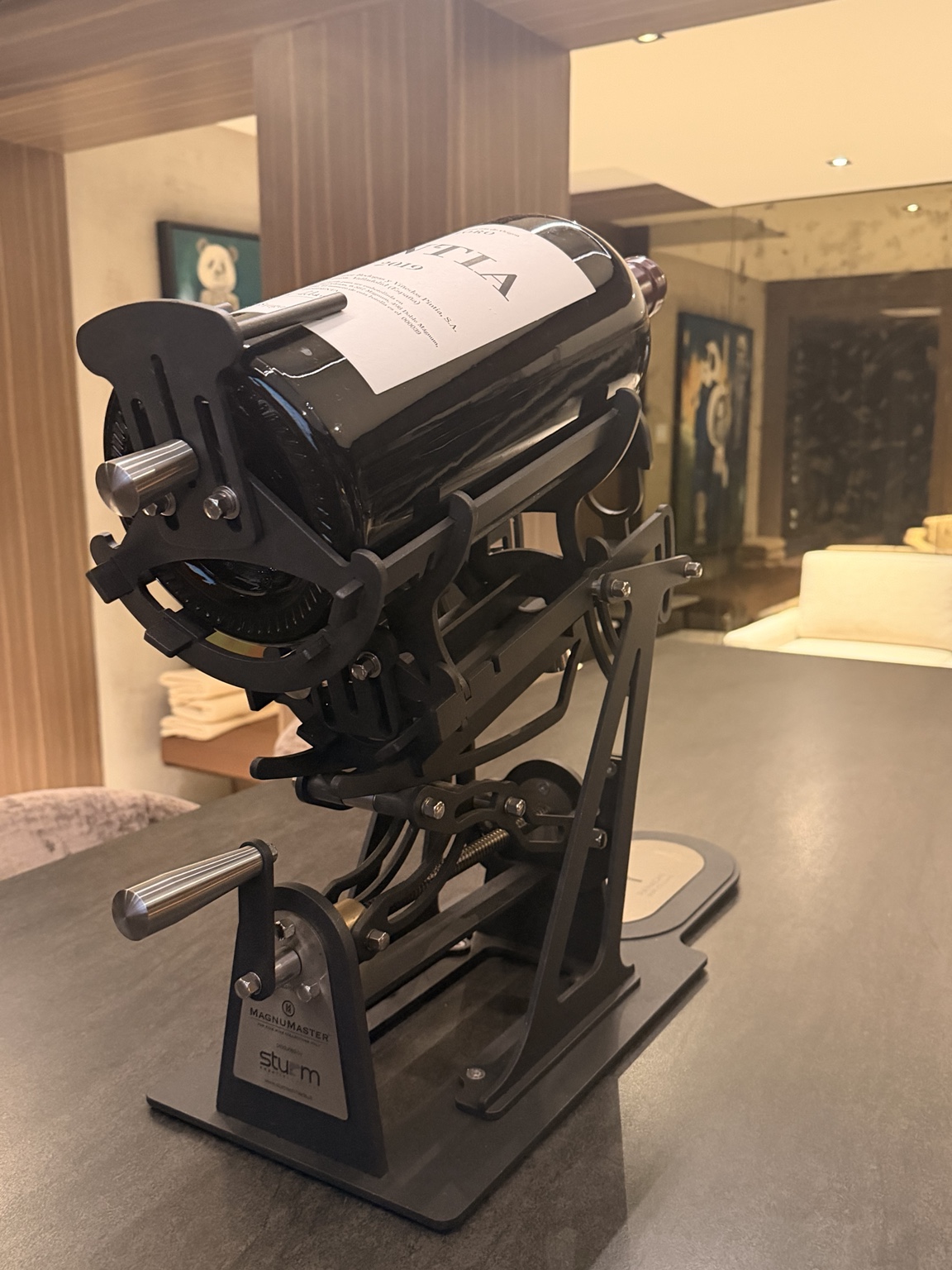 Angled view of the black MagnuMaster large-format wine decanting cradle